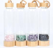 Load image into Gallery viewer, B.L.O.W. Co. Glass Water Bottle with Bamboo Lid & Crystals. 10 different stones from Amethyst, Aventurine, Tigers Eye, Rose Quartz, Clear Quartz, Citrine, Tourmaline, Red Jasper and MORE!! This also comes with a neoprene sleeve to keep your drinks cooler longer. This is available individually or as a gift set!!