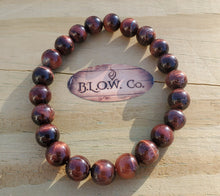Load image into Gallery viewer, This bracelet is available in 8mm and 10mm. Red Tigers eye is a stimulating stone and can support motivation and a more active sex drive. It's focus on the lower chakras is what gives Red Tiger Eye the power to send higher energies through the organs of the lower half of the body. Red Tiger Eye aids in enhancing confidence and self-esteem as well. It provides motivation to the non-motivated and energizes those who are feeling lethargic.