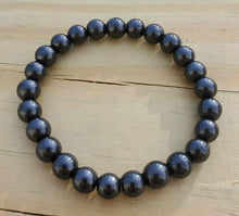 Load image into Gallery viewer, Shungite is a black stone with properties helping one who requires assistance in cleansing, healing, purification of the mind, body, and soul. First discovered from a deposit in remote Russia and is a carbon filled stone Shungite is said to kills bacteria and viruses. Fullerenes, which are found in shungite, are a type of carbon nanostructure (CNS). It purifies water, reduces oxidative stress, reduces inflammation, eases physical ailments, shields electromagnetic field (EMF) emissions, from electrical grids