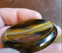 Load image into Gallery viewer, Tigers Eye is a powerful stone that helps you to release fear and anxiety and aids harmony and balance. It stimulates taking action, and helps you to make decisions with discernment and understanding and unclouded by your emotions.  Its healing properties are bringing insight into complex situations, protecting from negative energies, helping focus the mind, attracting good luck, deepening one's meditative state, grounding and centering personal energy, dispelling fears and promoting mental clarity.