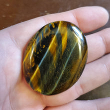 Load image into Gallery viewer, Tigers Eye is a powerful stone that helps you to release fear and anxiety and aids harmony and balance. It stimulates taking action, and helps you to make decisions with discernment and understanding and unclouded by your emotions.  Its healing properties are bringing insight into complex situations, protecting from negative energies, helping focus the mind, attracting good luck, deepening one's meditative state, grounding and centering personal energy, dispelling fears and promoting mental clarity.