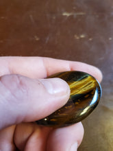 Load image into Gallery viewer, Tigers Eye is a powerful stone that helps you to release fear and anxiety and aids harmony and balance. It stimulates taking action, and helps you to make decisions with discernment and understanding and unclouded by your emotions.  Its healing properties are bringing insight into complex situations, protecting from negative energies, helping focus the mind, attracting good luck, deepening one's meditative state, grounding and centering personal energy, dispelling fears and promoting mental clarity.