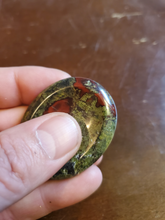 Load image into Gallery viewer, Dragon Bloodstone is mined in South Africa. Legend says the stone is the remains of deceased ancient dragons; the green being the skin and the red being the blood.

