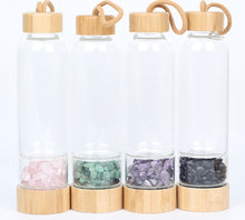 Load image into Gallery viewer, B.L.O.W. Co. Glass Water Bottle with Bamboo Lid &amp; Crystals. 10 different stones from Amethyst, Aventurine, Tigers Eye, Rose Quartz, Clear Quartz, Citrine, Tourmaline, Red Jasper and MORE!! This also comes with a neoprene sleeve to keep your drinks cooler longer. This is available individually or as a gift set!! 

