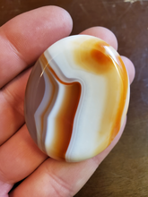 Load image into Gallery viewer, Carnelian is a stabilizing stone that restores vitality and motivation, and stimulates creativity. It gives courage, promotes positive life choices, dispels apathy and motivates for success. Carnelian is useful for overcoming abuse of any kind. It helps in trusting yourself and your perceptions.
